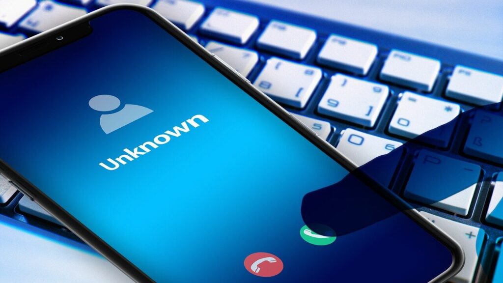 Smartphone with unknown caller ID — representing a typical bank phone call scam